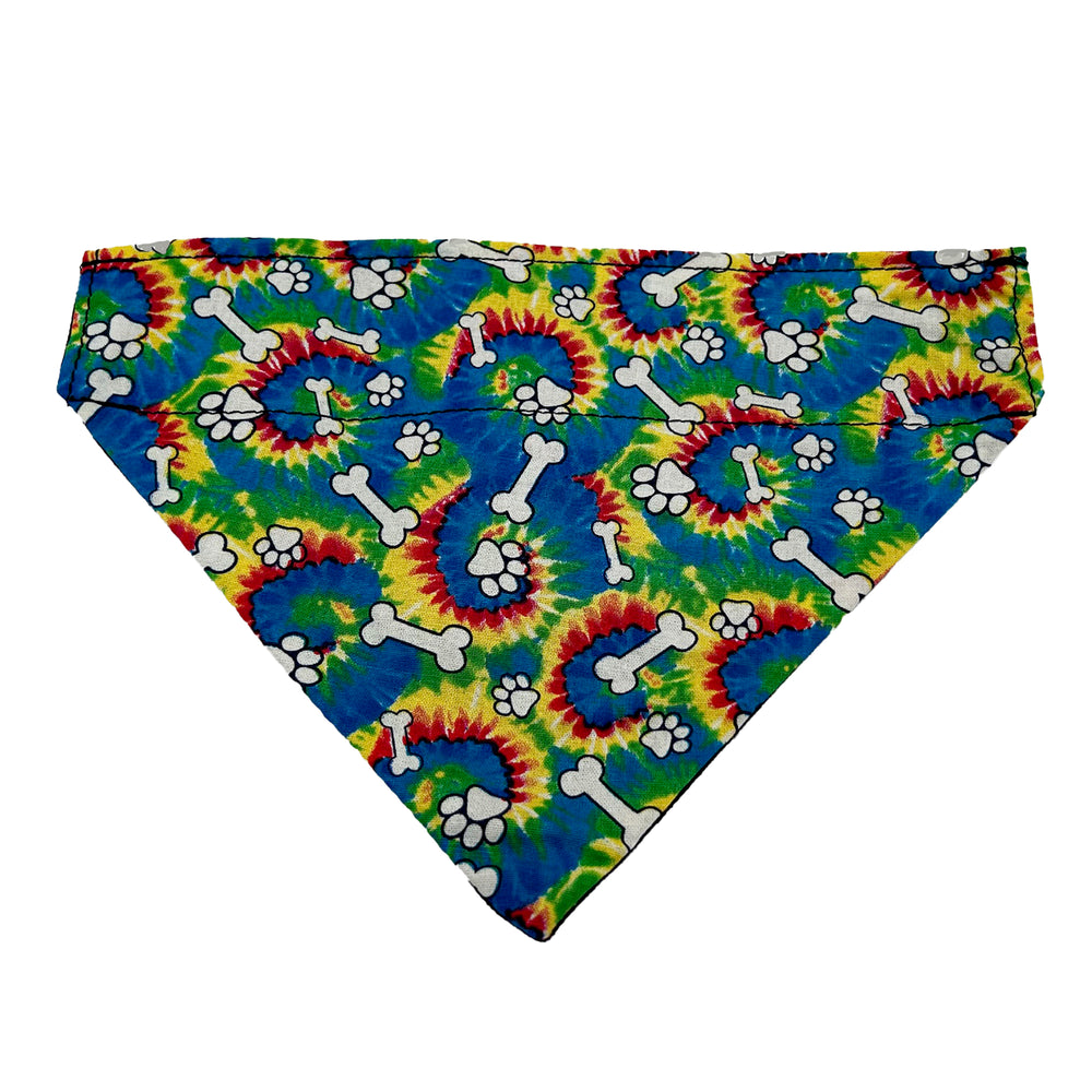 Slip on bandana with rainbow swirls and white dog paw prints and white bones