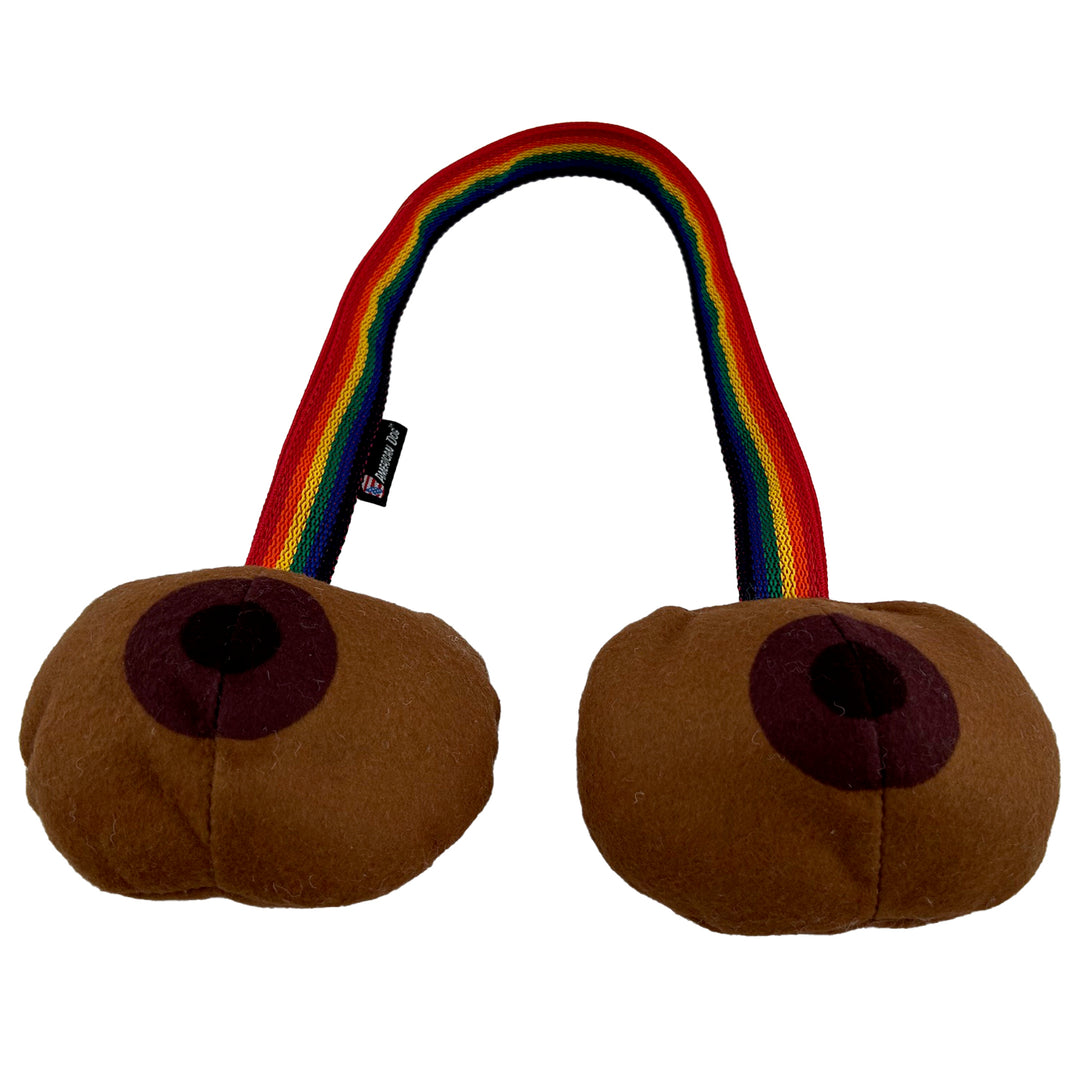 Brown toned dog tug toy shaped like boobs with a rainbow striped web connector