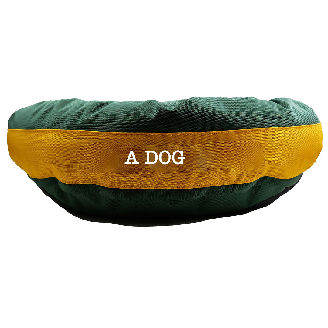 Side view of green dog bed with gold center band. 'A Dog' embroidy