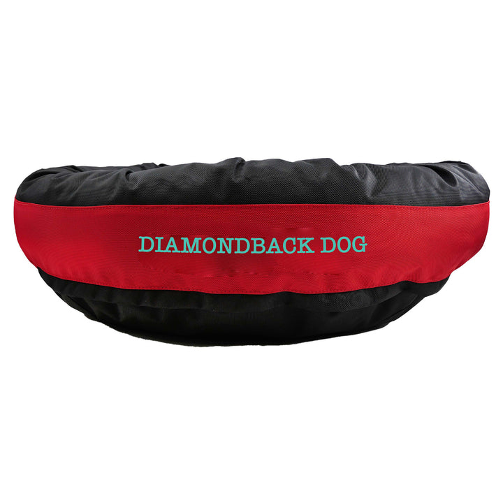 Black round bolstered dog bed with a red band with teal embroidered 'Diamondback Dog'