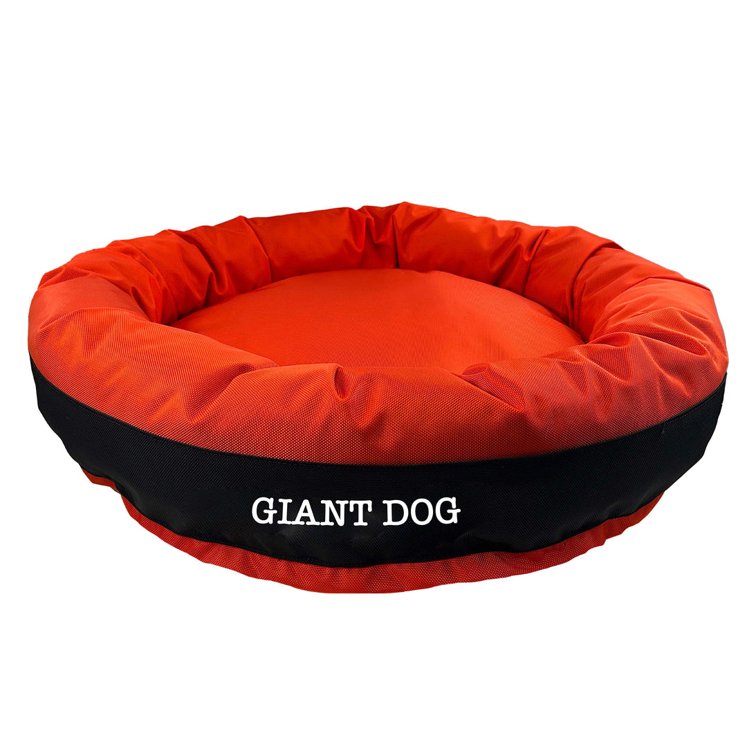 Orange round bolstered dog bed with black band and white embroidered 'Giant Dog'.