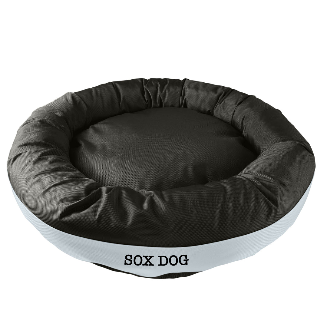 Black round bolstered dog bed with a silver band and black embroidered 'Soxs Dog'.