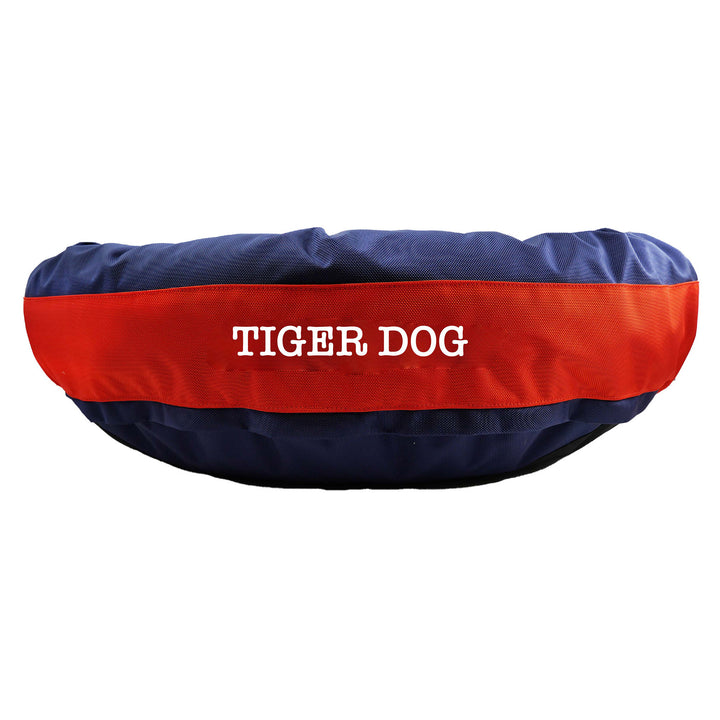 Navy round bolstered dog bed with an orange band and white embroidered 'Tiger Dog'.