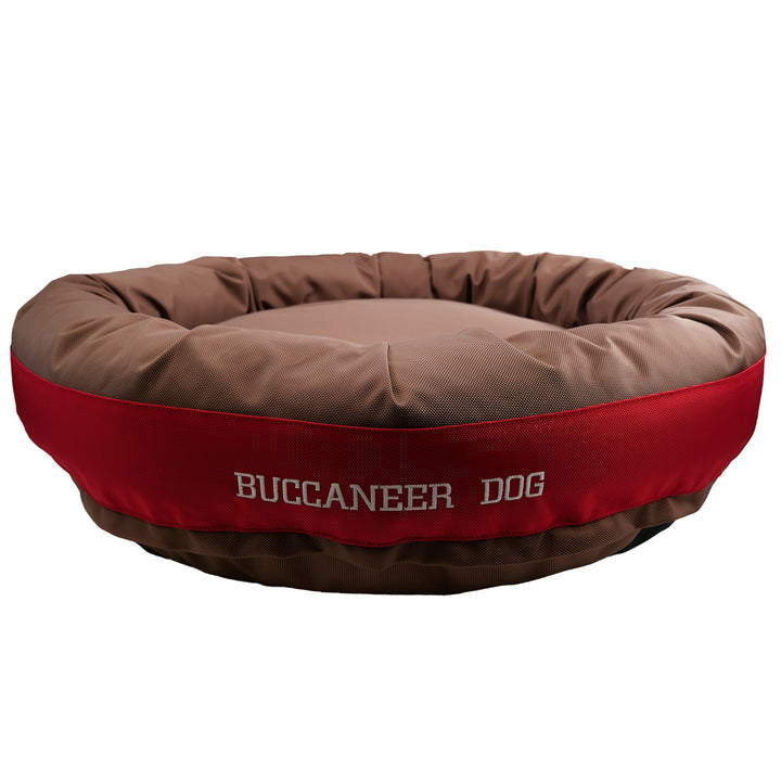 Brown and red round bolstered dog bed with Buccaneer Dog embroidered in white