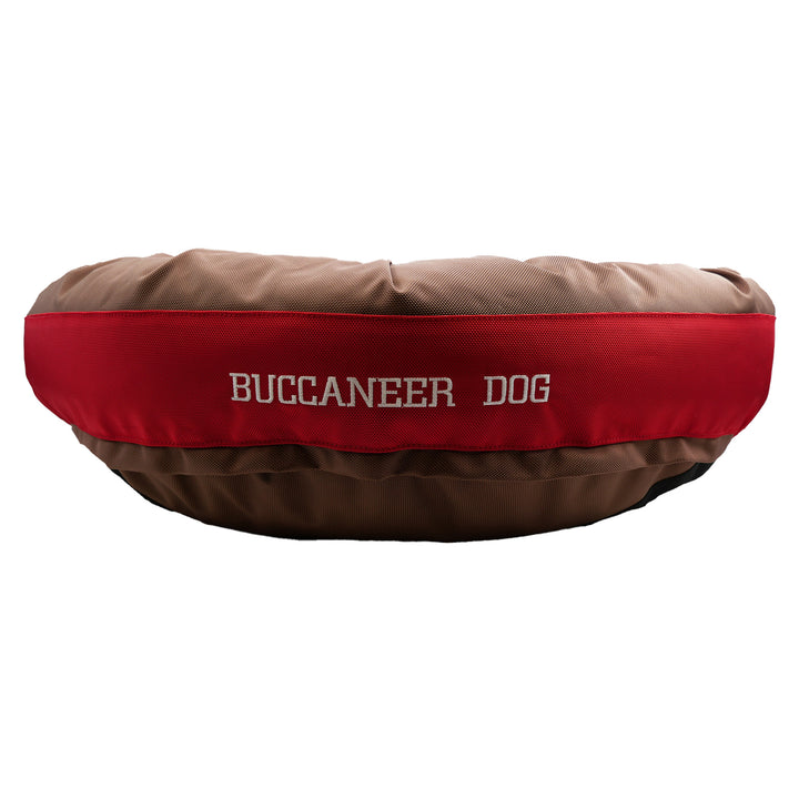 Brown and red round bolstered dog bed with Buccaneer Dog embroidered in white