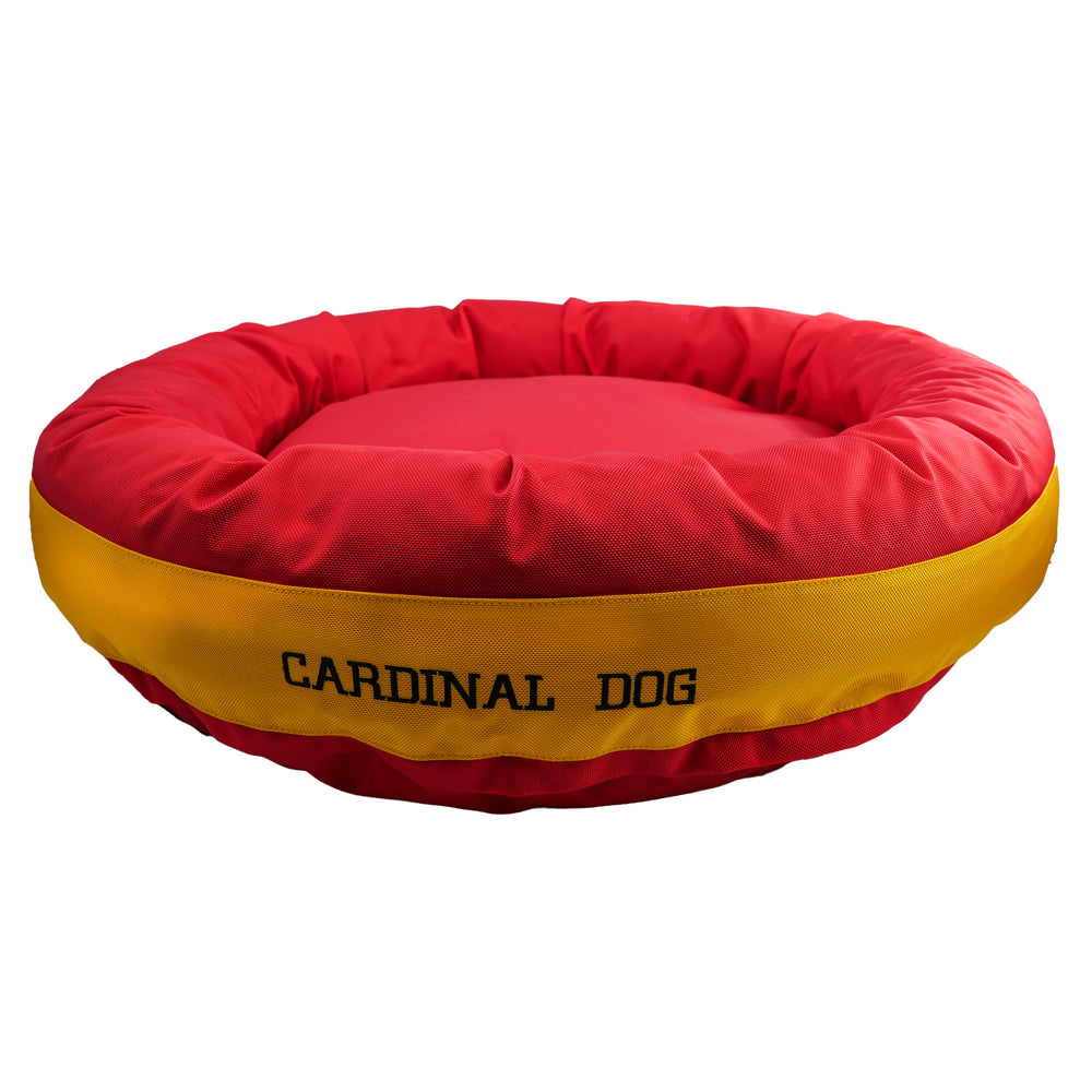 Red round bolstered dog bed with a yellow band with black embroidered 'CardinalDog'