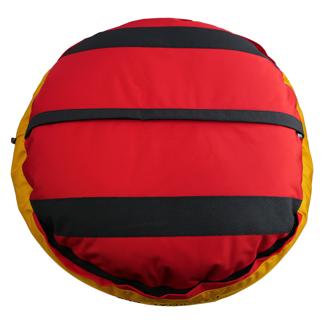 Bottom of Red round bolstered dog bed with a yellow band and black stripes