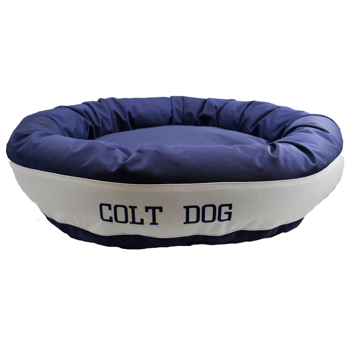 Dark blue and white bolstered dog bed with Colt Dog embroidered in dark blue