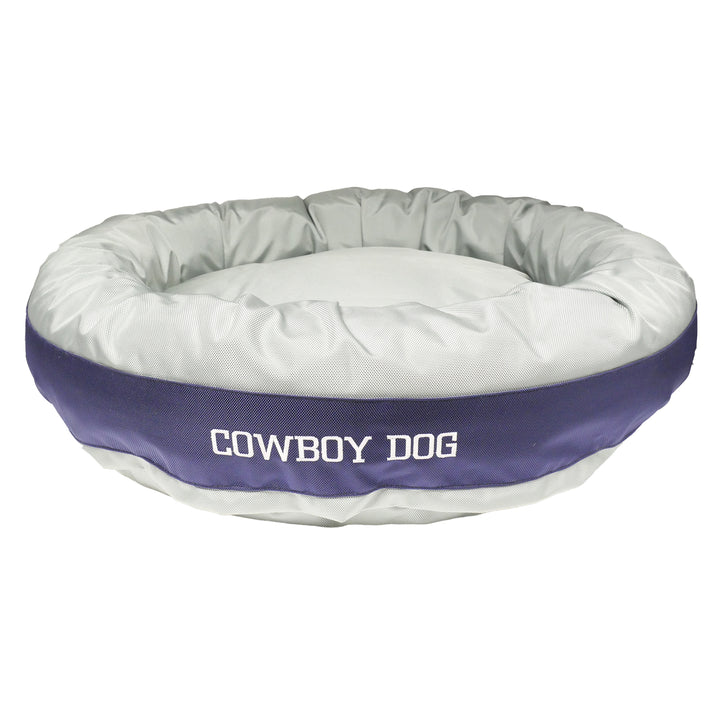 Silver round bolstered dog bed with navy band with white embroidered 'Cowboy Dog.