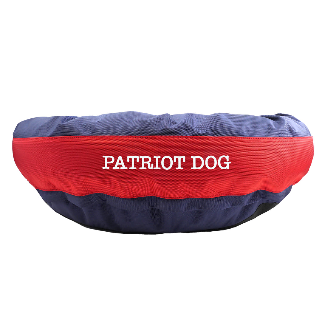 Blue and red round bolstered dog bed  with embroidered 'patriot dog'