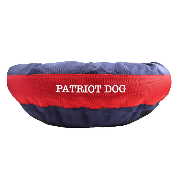 Blue and red round bolstered dog bed  with embroidered 'patriot dog'