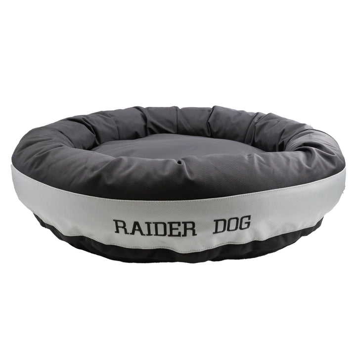 Black round bolstered dog bed with a silver band and black embroidered 'Raider Dog'.